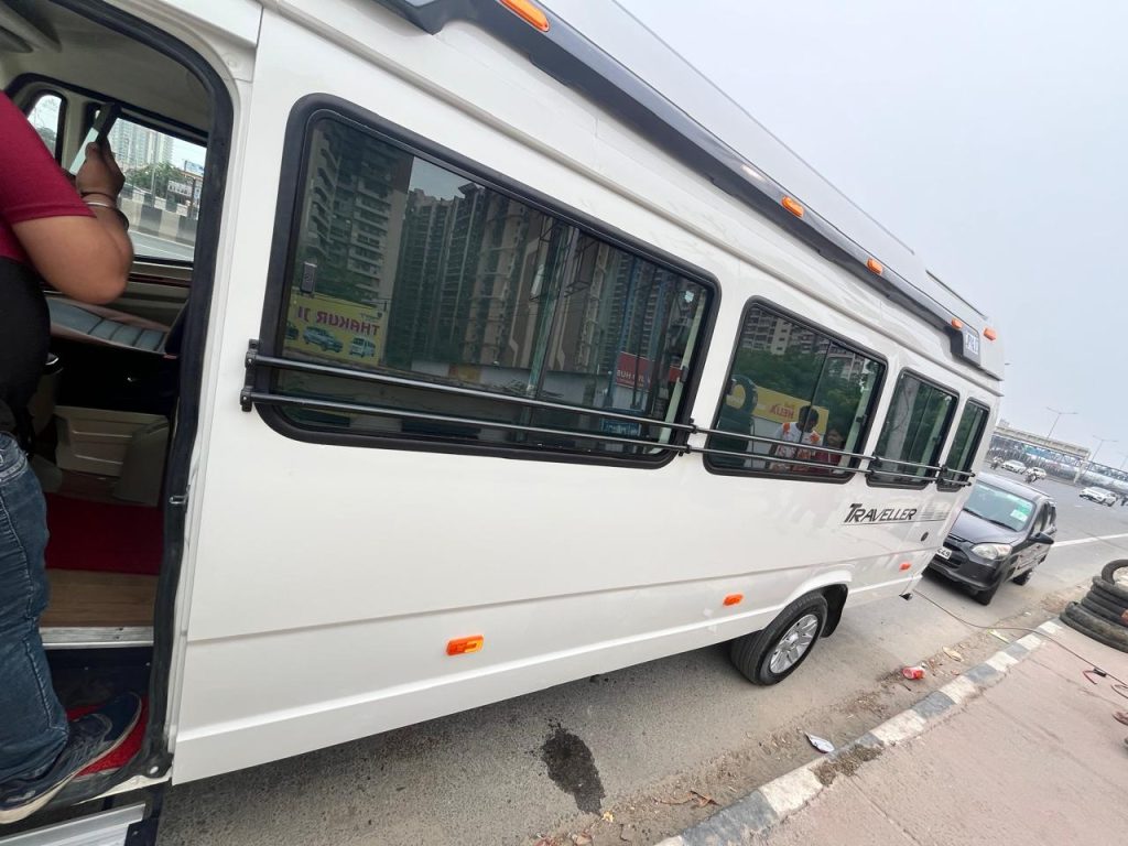 White Force Tempo Traveller side view with large sliding windows